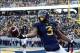 Nov 30, 2013; Morgantown, WV, USA; West Virginia Mountaineers running back Charles Sims (3) reacts after scoring a touchdown during the first quarter against the Iowa State Cyclones at Milan Puskar Stadium. Mandatory Credit: Tommy Gilligan-USA TODAY Sport