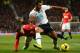 Mousa Dembele shows his supreme strength by muscling Wayne Rooney off the ball.