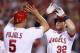 ANAHEIM, CA - JULY 04: Albert Pujols #5 and Josh Hamilton #32 of the Los Angeles Angels of Anaheim celebrate Hamilton's two-run home run against the St. Louis Cardinals in the ninth inning at Angel Stadium of Anaheim on July 4, 2013 in Anaheim, Californi