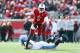 LOUISVILLE, KY - NOVEMBER 23: Teddy Bridgewater #5 of the Louisville Cardinals avoids the tackle of Chase Rome #47 of the Memphis Tigers at Papa John's Cardinal Stadium on November 23, 2013 in Louisville, Kentucky. (Photo by Andy Lyons/Getty Images)