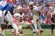 Nov 30, 2013; Gainesville, FL, USA; Florida State Seminoles quarterback Jameis Winston (5) calls a play to offensive linesman Bryan Stork (52) against the Florida Gators during the first quarter at Ben Hill Griffin Stadium. Mandatory Credit: Kim Klement-U