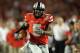 Jan 3, 2014; Miami Gardens, FL, USA; Ohio State Buckeyes quarterback Braxton Miller (5) runs for a touchdown in the first half against the Clemson Tigers during the 2014 Orange Bowl college football game at Sun Life Stadium. Mandatory Credit: Steve Mitche
