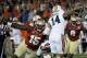 Jan 6, 2014; Pasadena, CA, USA; Florida State Seminoles defensive end Mario Edwards Jr. (15) tries to sack Auburn Tigers quarterback Nick Marshall (14) during the first half of the 2014 BCS National Championship game at the Rose Bowl. Mandatory Credit: R