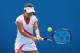 MELBOURNE, AUSTRALIA - JANUARY 17: Jie Zheng of China plays a backhand in her first round doubles match with Nuria Llagostera Vives of Spain against Hao-Ching Chan of Chinese Taipei and Yung-Jan Chan of Chinese Taipei during day four of the 2013 Austral