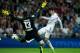 MADRID, SPAIN - SEPTEMBER 28: Alvaro Morata of Real Madrid CF strikes the ball past goalkeeper Thibaut Courtois of Atletico de Madrid during the La Liga match between Real Madrid CF and Club Atletico de Madrid at Estadio Santiago Bernabeu on September 28,