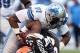 Aug 15, 2013; Cleveland, OH, USA; Cleveland Browns running back Trent Richardson (33) is tackled by Detroit Lions defensive end Jason Jones (91) and defensive end Ezekiel Ansah (94) during the first quarter at FirstEnergy Field. Mandatory Credit: Ron Schw