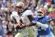 Nov 30, 2013; Gainesville, FL, USA; Florida State Seminoles wide receiver Kelvin Benjamin (1) runs in a touchdown as Florida Gators defensive back Brian Poole (24) defends during the second quarter at Ben Hill Griffin Stadium. Mandatory Credit: Steve Mitc