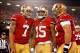 Jan 12, 2013; San Francisco, CA, USA; San Francisco 49ers wide receiver Michael Crabtree (15) celebrates with quarterback Colin Kaepernick (7) and center Jonathan Goodwin (59) after scoring a touchdown against the Green Bay Packers during the second quart