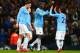 MANCHESTER, ENGLAND - JANUARY 08: Yaya Toure of Manchester City celebrates scoring their third goal with David Silva of Manchester City during the Capital One Cup Semi-Final first leg match between Manchester City and West Ham United at Etihad Stadium on