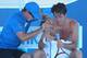 MELBOURNE, AUSTRALIA - JANUARY 13: Tommy Haas of Germany is treated by a trainer in his first round match against Guillermo Garcia-Lopez of Spain during day one of the 2014 Australian Open at Melbourne Park on January 13, 2014 in Melbourne, Australia. (