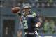 Jan 11, 2014; Seattle, WA, USA; Seattle Seahawks quarterback Russell Wilson (3) passes the ball against the New Orleans Saints during the first half of the 2013 NFC divisional playoff football game at CenturyLink Field. Mandatory Credit: Kirby Lee-USA TOD