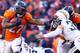 DENVER, CO - JANUARY 12: Knowshon Moreno #27 of the Denver Broncos carries the ball against the defense of Eric Weddle #32 of the San Diego Chargers in the second quarter during the AFC Divisional Playoff Game at Sports Authority Field at Mile High on J