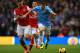 MANCHESTER, ENGLAND - DECEMBER 14: James Milner of Manchester City and Thomas Vermaelen of Arsenal compete for the ball during the Barclays Premier League match between Manchester City and Arsenal at Etihad Stadium on December 14, 2013 in Manchester, Engl