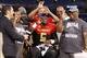 The Fournette family—Lori, Leonard and Leonard Sr.—hold up "B's" for Buga Nation as Leonard commits to LSU on Jan. 2 at the Under Armour All-America game.