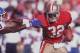 12 AUG 1994: SAN FRANCISCO RUNNING BACK RICKEY WATTERS STIFF ARMS A DENVER DEFENDER DURING THE 49ERS 20-3 VICTORY OVER THE BRONCOS, IN A PRESEASON GAME AT CANDLESTICK PARK IN SAN FRANCISCO, CALIFORNIA. Mandatory Credit: Otto Greule/ALLSPORT