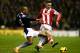 STOKE ON TRENT, ENGLAND - JANUARY 12: Glen Johnson of Liverpool tackles Marko Arnautovic of Stoke City during the Barclays Premier League match between Stoke City and Liverpool at Britannia Stadium on January 12, 2014 in Stoke on Trent, England. (Photo