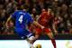 LIVERPOOL, ENGLAND - JANUARY 01: Philippe Coutinho of Liverpool competes with Alex Bruce of Hull City for the ball during the Barclays Premier League match between Liverpool and Hull City at Anfield on January 1, 2014 in Liverpool, England. (Photo by Cl