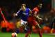 LIVERPOOL, ENGLAND - JANUARY 05: James Dayton of Oldham goes past Raheem Sterling of Liverpool during the Budweiser FA Cup third round match between Liverpool and Oldham Athletic at Anfield on January 5, 2014 in Liverpool, England. (Photo by Clive Mason/
