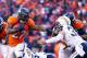 DENVER, CO - JANUARY 12: Knowshon Moreno #27 of the Denver Broncos carries the ball against the defense of Eric Weddle #32 of the San Diego Chargers in the second quarter during the AFC Divisional Playoff Game at Sports Authority Field at Mile High on J
