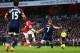 LONDON, ENGLAND - JANUARY 18: Santi Cazorla of Arsenal (C) shoots past Steve Sidwell of Fulham to score their second goal during the Barclays Premier League match between Arsenal and Fulham at Emirates Stadium on January 18, 2014 in London, England. (Ph