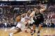 Dec 20, 2013; Philadelphia, PA, USA; Philadelphia 76ers guard Evan Turner (12) is defended by Brooklyn Nets center Brook Lopez (11) during the fourth quarter at the Wells Fargo Center. The Sixers defeated the Nets 121-120 in overtime. Mandatory Credit: Ho