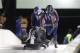 Jones pushing the bobsled.