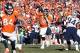Jan 19, 2014; Denver, CO, USA; Denver Broncos quarterback Peyton Manning (18) throws a pass in the second half against the New England Patriots during the 2013 AFC championship playoff football game at Sports Authority Field at Mile High. Mandatory Credit