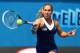 MELBOURNE, AUSTRALIA - JANUARY 18: Dominika Cibulkova of Slovakia plays a forehand in her third round match against Carla Suarez Navarro of Spain during day six of the 2014 Australian Open at Melbourne Park on January 18, 2014 in Melbourne, Australia. (