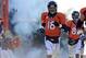 Dec 8, 2013; Denver, CO, USA; Denver Broncos quarterback Peyton Manning (18) enters the field before the start of the first quarter against the Tennessee Titans at Sports Authority Field at Mile High. Mandatory Credit: Ron Chenoy-USA TODAY Sports