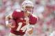 TALLAHASSEE, FL - OCTOBER 5: Jacob Coker #14 of the Florida State Seminoles looks for a hole during the second half on October 5, 2013 at Doak Campbell Stadium in Tallahassee, Florida. Coker went to score and led the Seminoles to a 63-0 victory over the T