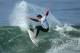 HUNTINGTON BEACH, CA - JULY 19: Peter Mel (USA) slashes a turn on an inside wave in Heat 3 of the Round of 172 of the 2009 Hurley U.S. Open of Surfing on July 19, 2009 in Huntington Beach, California. (Photo by Victor Decolongon/Getty Images)