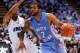 CHAPEL HILL, NC - DECEMBER 31: Craig Ponder #00 of the North Carolina-Wilmington Seahawks defends a drive by Leslie McDonald #2 of the North Carolina Tar Heels during their game at Dean Smith Center on December 31, 2013 in Chapel Hill, North Carolina. No