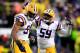 BATON ROUGE, LA - NOVEMBER 23: Defensive end Danielle Hunter #94 of the LSU Tigers celebrates with his teammate defensive end Jermauria Rasco #59 after sacking quarterback Johnny Manziel #2 of the Texas A&M Aggies at Tiger Stadium on November 23, 2013 i