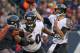 CHICAGO, IL - NOVEMBER 17: Joe Flacco #5 of the Baltimore Ravens passes as Eugene Monroe #60 blocks Julius Peppers #90 of the Chicago Bears at Soldier Field on November 17, 2013 in Chicago, Illinois. The Bears defeated the Ravens 23-20 in overtime. (Pho