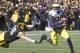 IOWA CITY, IA - NOVEMBER 23: Quarterback Devin Gardner #98 of the Michigan Wolverines breaks a tackle during the second quarter by defensive lineman Mike Hardy #98 of the Iowa Hawkeyes on November 23, 2013 at Kinnick Stadium in Iowa City, Iowa. (Photo b