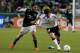PORTLAND, OR - MAY 23: Pablo Piatti #14 of Valencia is tripped up by Mike Chabala #4 of the Portland Timbers at Jeld-Wen Field on May 23, 2012 in Portland, Oregon. (Photo by Jonathan Ferrey/Getty Images)