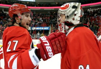 RALEIGH, NC - JANUARY 25: Justin Faulk #27 of the Carolina Hurricanes celebrates his team's 6-3 victory over the Ottawa Senators with winning goaltender Anton Khudobin #31 during their NHL game at PNC Arena on January 25, 2014 in Raleigh, North Carolina. 
