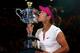 MELBOURNE, AUSTRALIA - JANUARY 25: Na Li of China kisses the Daphne Akhurst Memorial Cup after winning the women's final match against Dominika Cibulkova of Slovakia during day 13 of the 2014 Australian Open at Melbourne Park on January 25, 2014 in Melbo