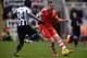 NEWCASTLE UPON TYNE, ENGLAND - DECEMBER 14: Cheick Tiote of Newcastle United tackles Luke Shaw of Southampton during the Barclays Premier League match between Newcastle United and Southampton at St James' Park on December 14, 2013 in Newcastle upon Tyne,
