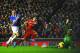 LIVERPOOL, ENGLAND - JANUARY 28: Luis Suarez of Liverpool scores his team's fourth goal past goalkeeper Tim Howard of Everton as Phil Jagielka of Everton closes in during the Barclays Premier League match between Liverpool and Everton at Anfield on Janua