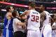 Oct 31, 2013; Los Angeles, CA, USA; NBA referee Mark Ayotte (56) and Los Angeles Clippers power forward Blake Griffin (32) separate center DeAndre Jordan (6) after he was fouled by Golden State Warriors center Andrew Bogut (far left) in the second quart