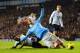 LONDON, ENGLAND - JANUARY 29: Danny Rose of Tottenham Hotspur fouls Edin Dzeko of Manchester City in the area during the Barclays Premier League match between Tottenham Hotspur and Manchester City at White Hart Lane on January 29, 2014 in London, England