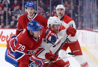 MONTREAL, QC - JANUARY 28:  Andrei Markov #79 of the Montreal Canadiens challenges Riley Nash #20 of the Carolina Hurricanes during the NHL game on January 28, 2014 at the Bell Centre in Montreal, Quebec, Canada.  (Photo by Francois Lacasse/NHLI via Getty