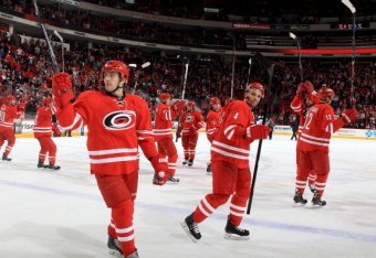 RALEIGH, NC - JANUARY 31: Tuomo Ruutu #15 of the Carolina Hurricanes and teammates salute fans following their victory over the St. Louis Blues during their NHL game at PNC Arena on January 31, 2014 in Raleigh, North Carolina.  (Photo by Gregg Forwerck/NH