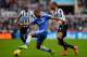 NEWCASTLE UPON TYNE, ENGLAND - NOVEMBER 02: Loic Remy of Newcastle United and Ashley Cole of Chelsea compete for the ball during the Barclays Premier League match between Newcastle United and Chelsea at St James' Park on November 2, 2013 in Newcastle up