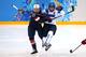 SOCHI, RUSSIA - FEBRUARY 08: Kacey Bellamy #22 of United States checks Nina Tikkinen #23 of Finland during the Women's Ice Hockey Preliminary Round Group A Game on day 1 of the Sochi 2014 Winter Olympics at Shayba Arena on February 8, 2014 in Sochi, Russ