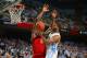 Feb 4, 2014; Chapel Hill, NC, USA; North Carolina Tar Heels guard Leslie McDonald (2) shoots as Maryland Terrapins forward Charles Mitchell (0) defends in the second half. The North Carolina Tar Heels defeated the Maryland Terrapins 75-63 at Dean E. Smith