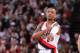 PORTLAND, OR - JANUARY 28: Damian Lillard #0 of the Portland Trail Blazers stands on the court against the Memphis Grizzlies on January 28, 2014 at the Moda Center Arena in Portland, Oregon. NOTE TO USER: User expressly acknowledges and agrees that, by d