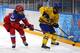 SOCHI, RUSSIA - FEBRUARY 13: Jenni Asserholt #4 of Sweden handles the puck against Svetlana Tkachyova #34 of Russia in the third period during the Women's Ice Hockey Preliminary Round Group B game on day six of the Sochi 2014 Winter Olympics at Shayba Are