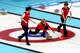 SOCHI, RUSSIA - FEBRUARY 14: Teammates Ann Swisshlem, Erika Brown and Jessica Shultz of the USA compete against Denmark during the Women's Curling Round Robin match on day seven of the Sochi 2014 Winter Olympics at Ice Cube Curling Center on February 14,